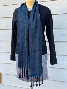 Blue and black handwoven scarf with fringe on mannequin 